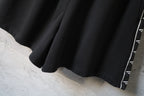 Balenciaga black shorts hem with contrast logo stripe edging along leg opening