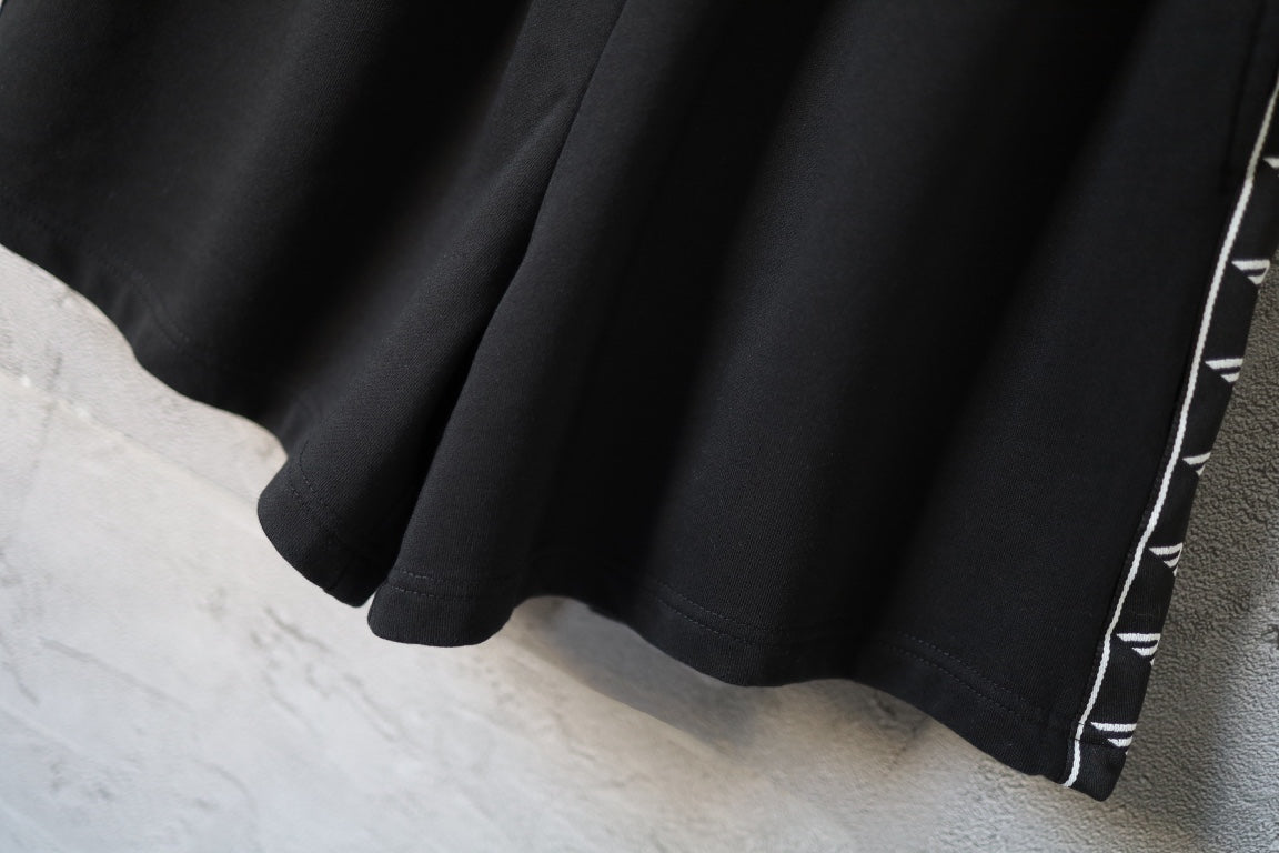 Balenciaga black shorts hem with contrast logo stripe edging along leg opening