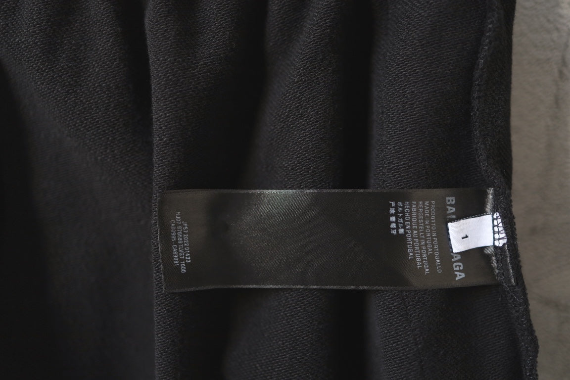Balenciaga black shorts with fabric care label near waistband interior