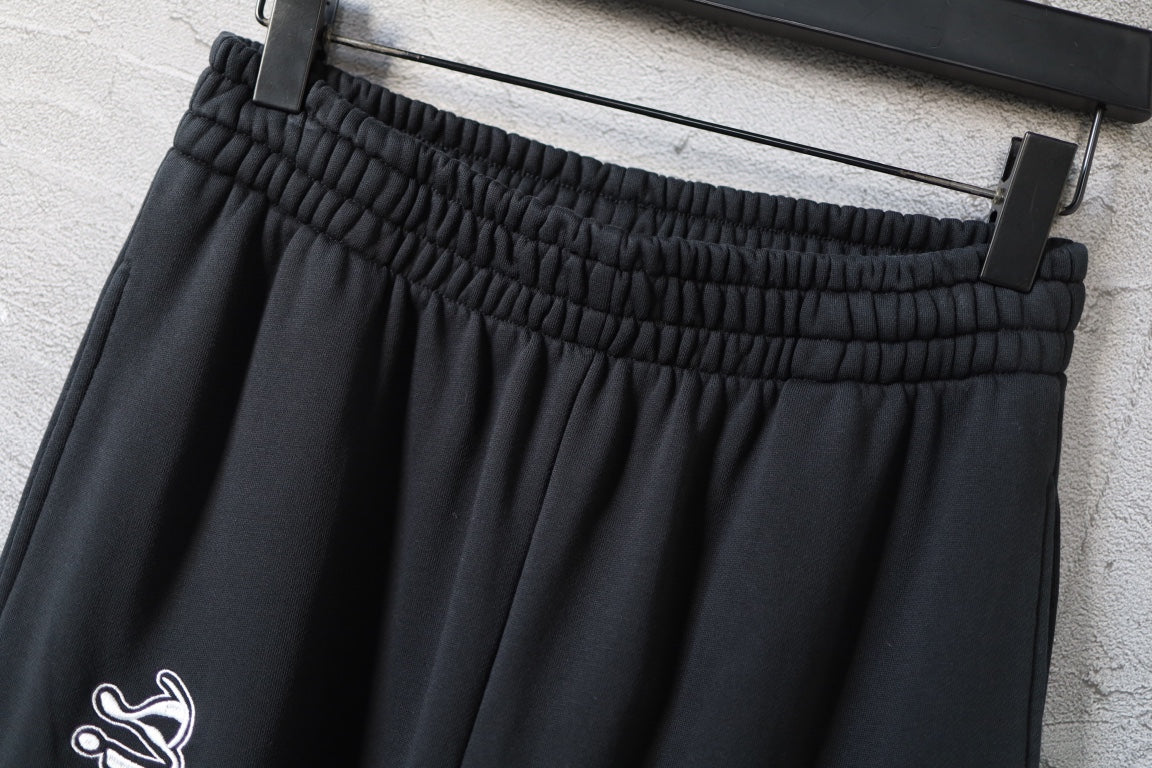 Balenciaga black wide-leg pants with elastic waistband and stitched drape seams