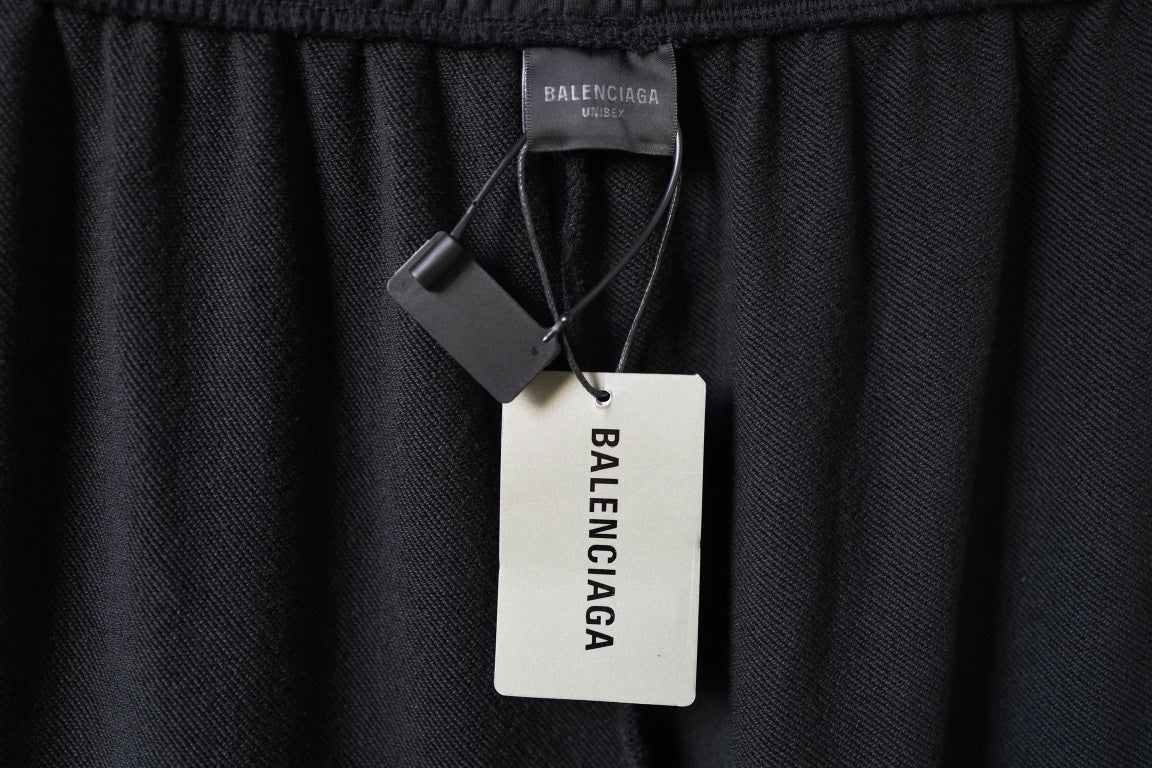 Balenciaga black pants interior with small label and attached hang tags