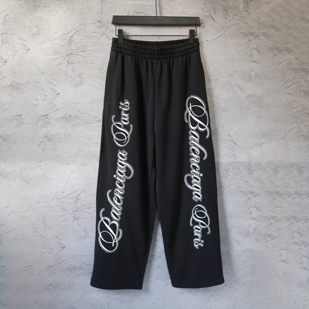 Black wide-leg pants with elastic waistband and white script logo print