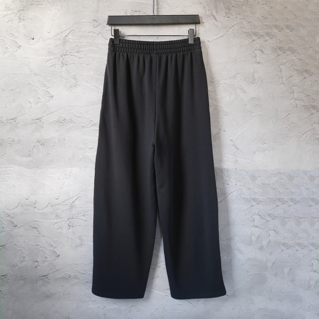 Black wide-leg pants with elastic waistband and no visible front logo