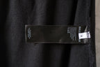 Balenciaga black pants fabric label and care tag inside leg seam