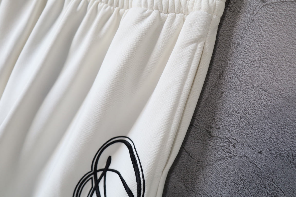 White Balenciaga pants with ribbed elastic waist and black logo print