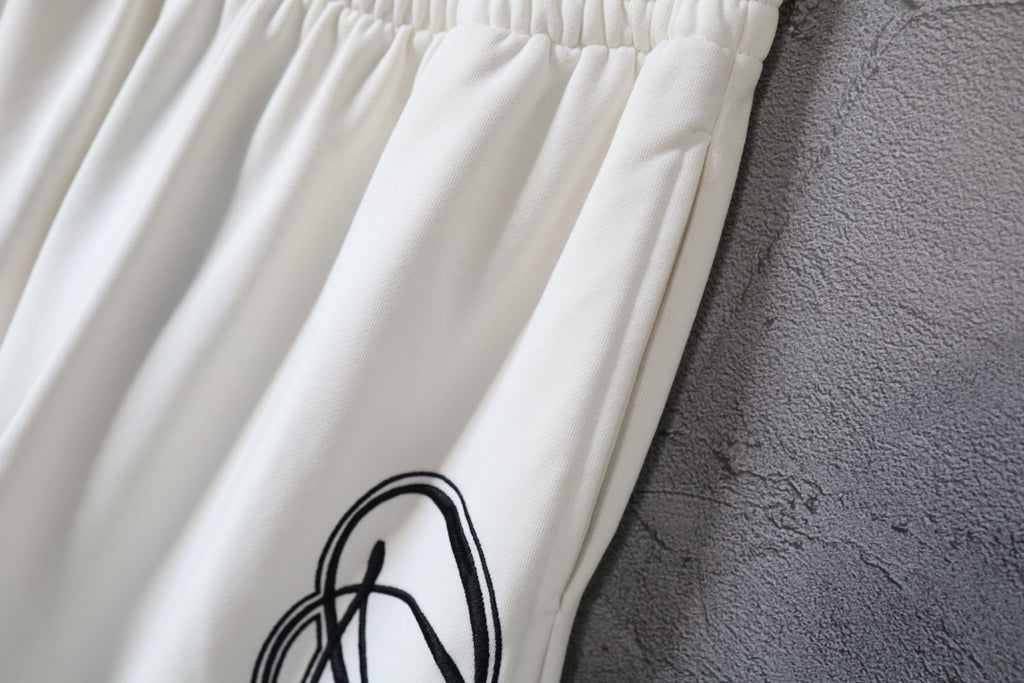 White pants with gathered elastic waistband and side logo print