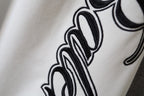 White Balenciaga pants fabric with large black logo lettering