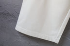 White Balenciaga pants with straight cuffed hem