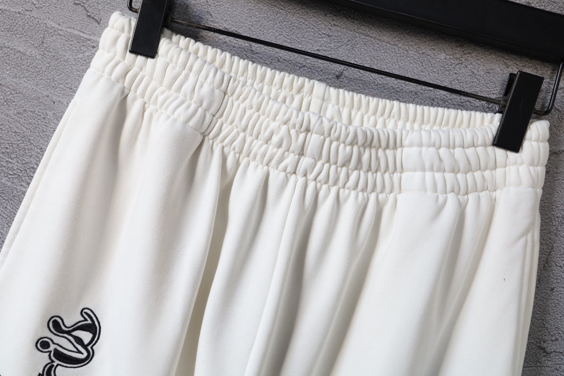 White pants with elastic waistband and gathered pleats at the top