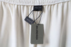 White pants with Balenciaga hang tag attached to the elastic waistband