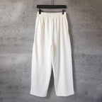 White Balenciaga wide-leg pants with elastic waistband, front view
