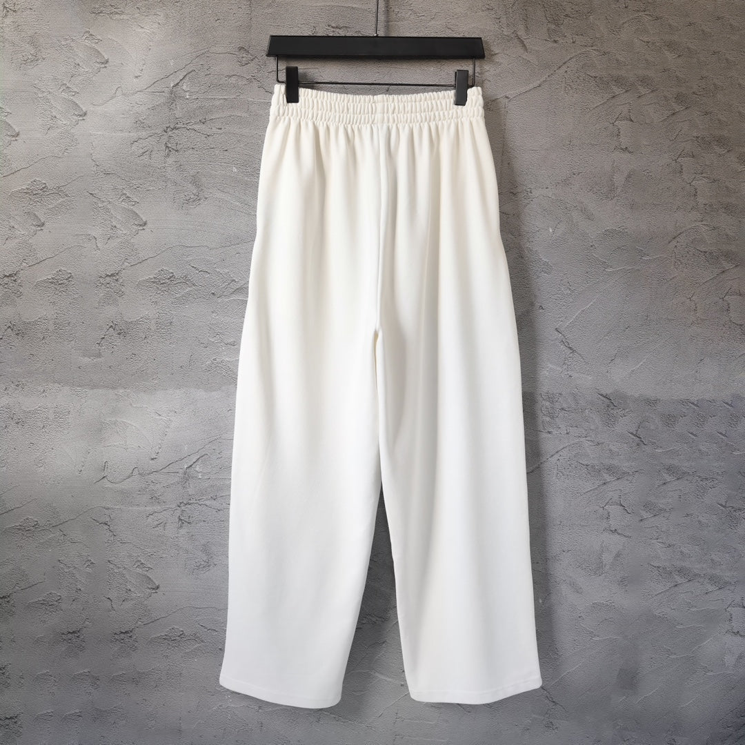 White Balenciaga wide-leg pants with elastic waistband, front view