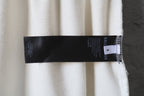 White pants with Balenciaga brand label tag at the hem