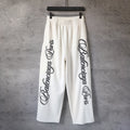 White Balenciaga wide-leg pants with elastic waist and black side logo print