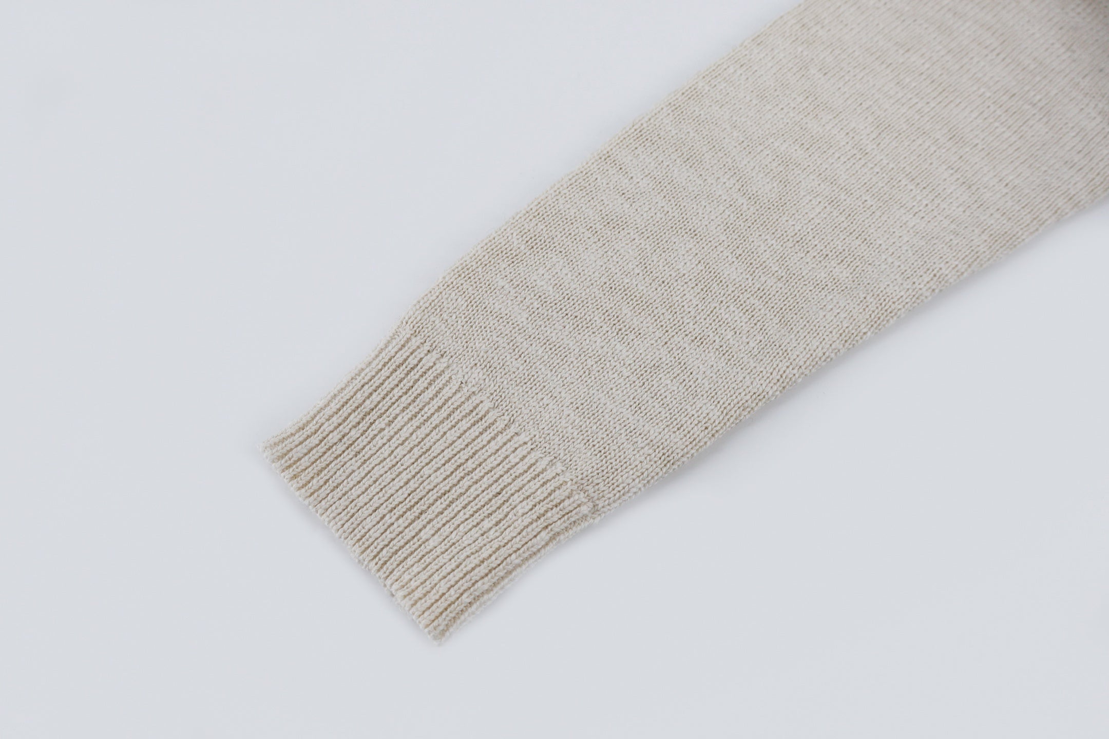 Light beige knit sweater cuff detail, ribbed hem on sleeve