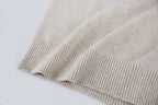 Light beige knit sweater ribbed hem detail at bottom