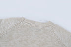 Light beige knit sweater shoulder and neckline close-up, ribbed collar