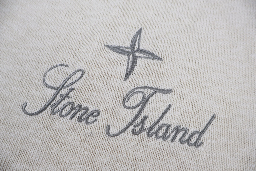 Stone Island logo on light beige knit sweater, star and script text