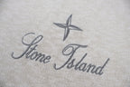 Stone Island logo on light beige knit sweater, star and script text