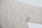Light beige knit sweater sleeve and shoulder seam detail
