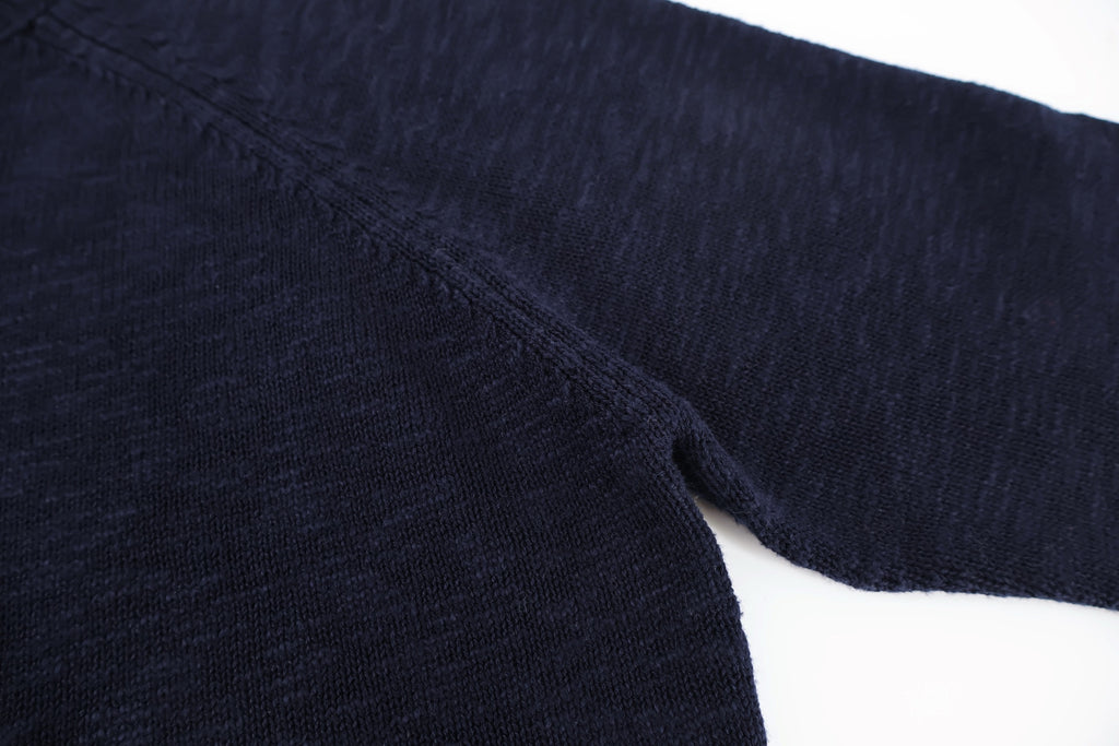Dark navy knit sweater sleeve and side seam detail