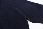 Dark navy knit sweater sleeve and side seam detail