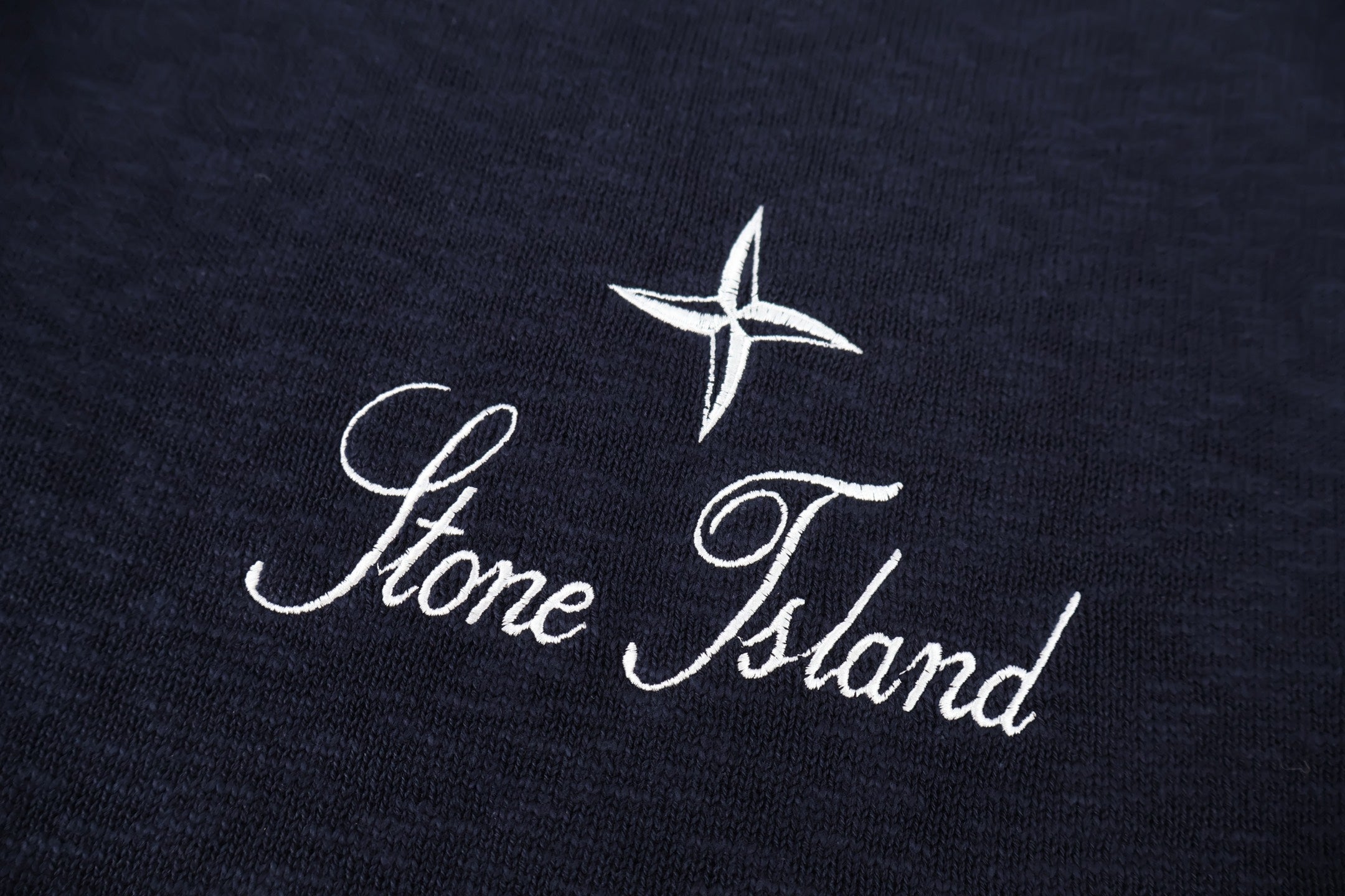 Stone Island star and script logo on dark navy knit sweater
