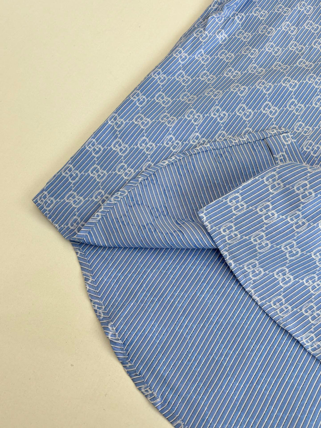 Blue Gucci long-sleeve shirt with allover logo pattern, draped side