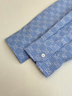 Blue Gucci long-sleeve shirt with allover logo pattern and white button
