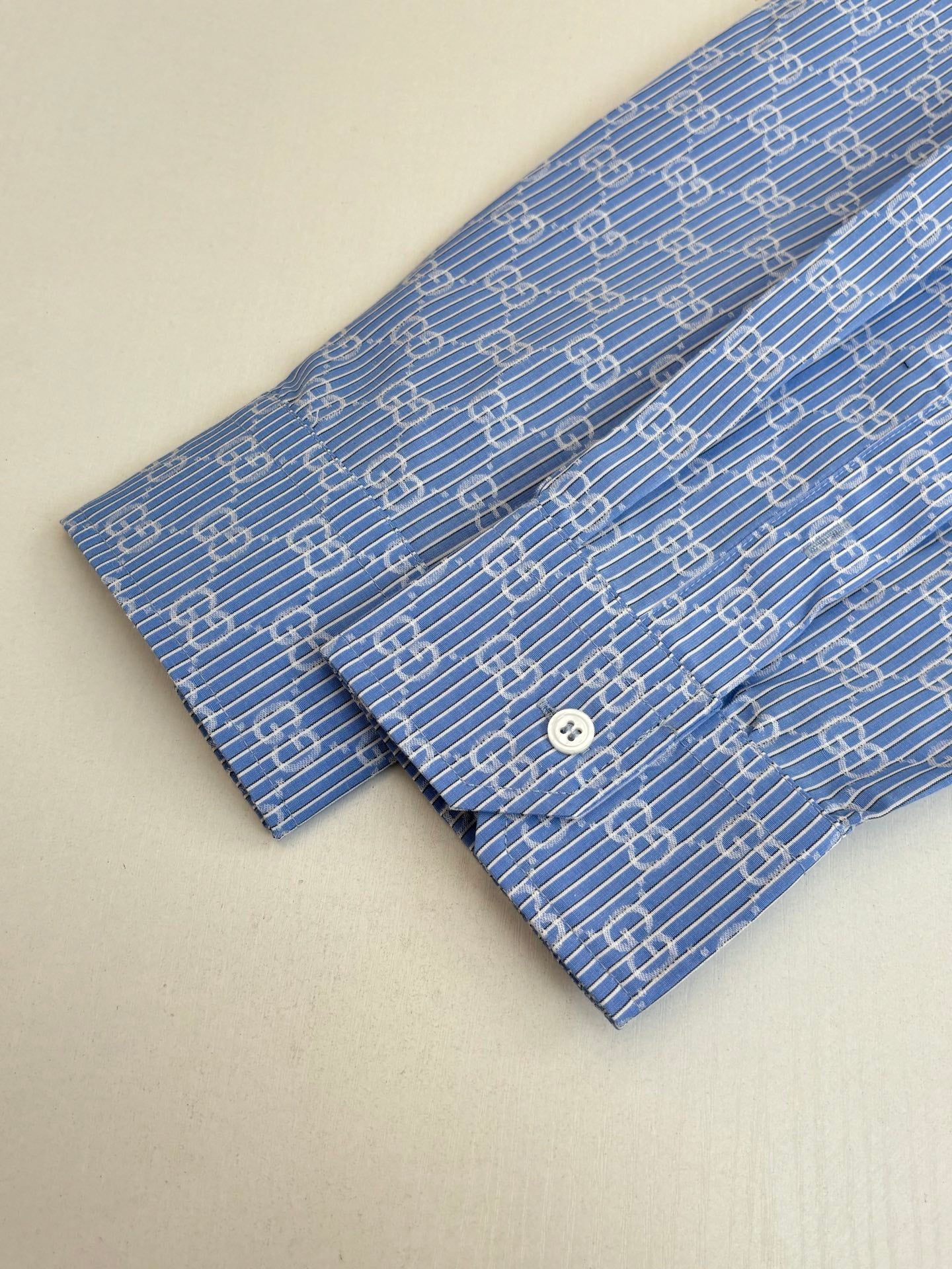 Blue Gucci long-sleeve shirt with allover logo pattern and white button