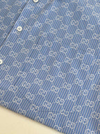 Blue Gucci long-sleeve shirt fabric with allover logo pattern and white buttons