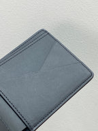 Blue leather wallet card holder with top edge stitching and folded corner