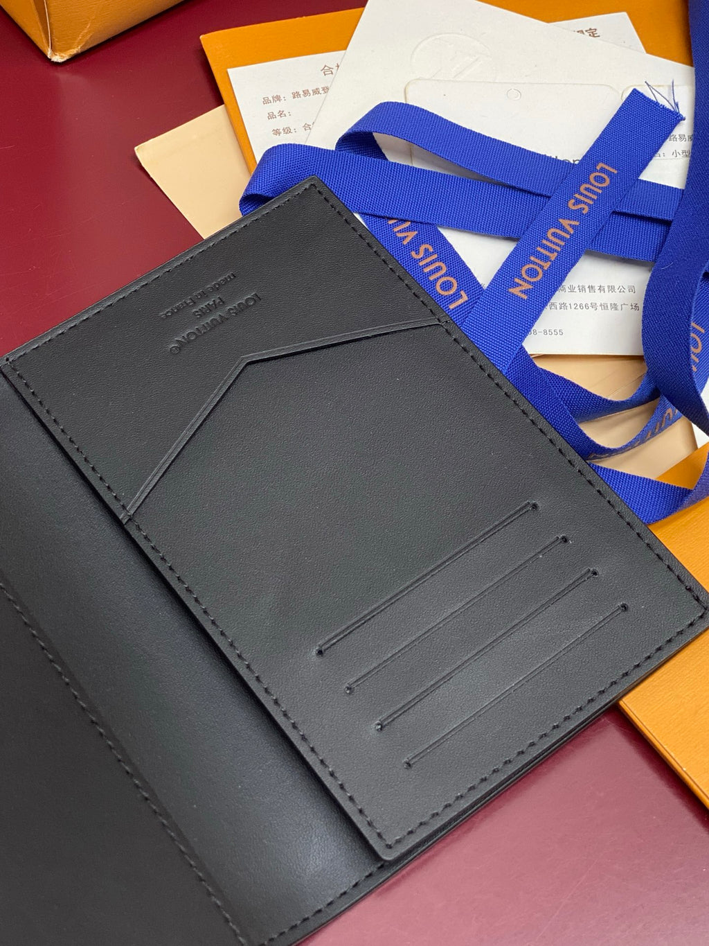 Black textured leather small bag interior with card slot stitching and pocket flap