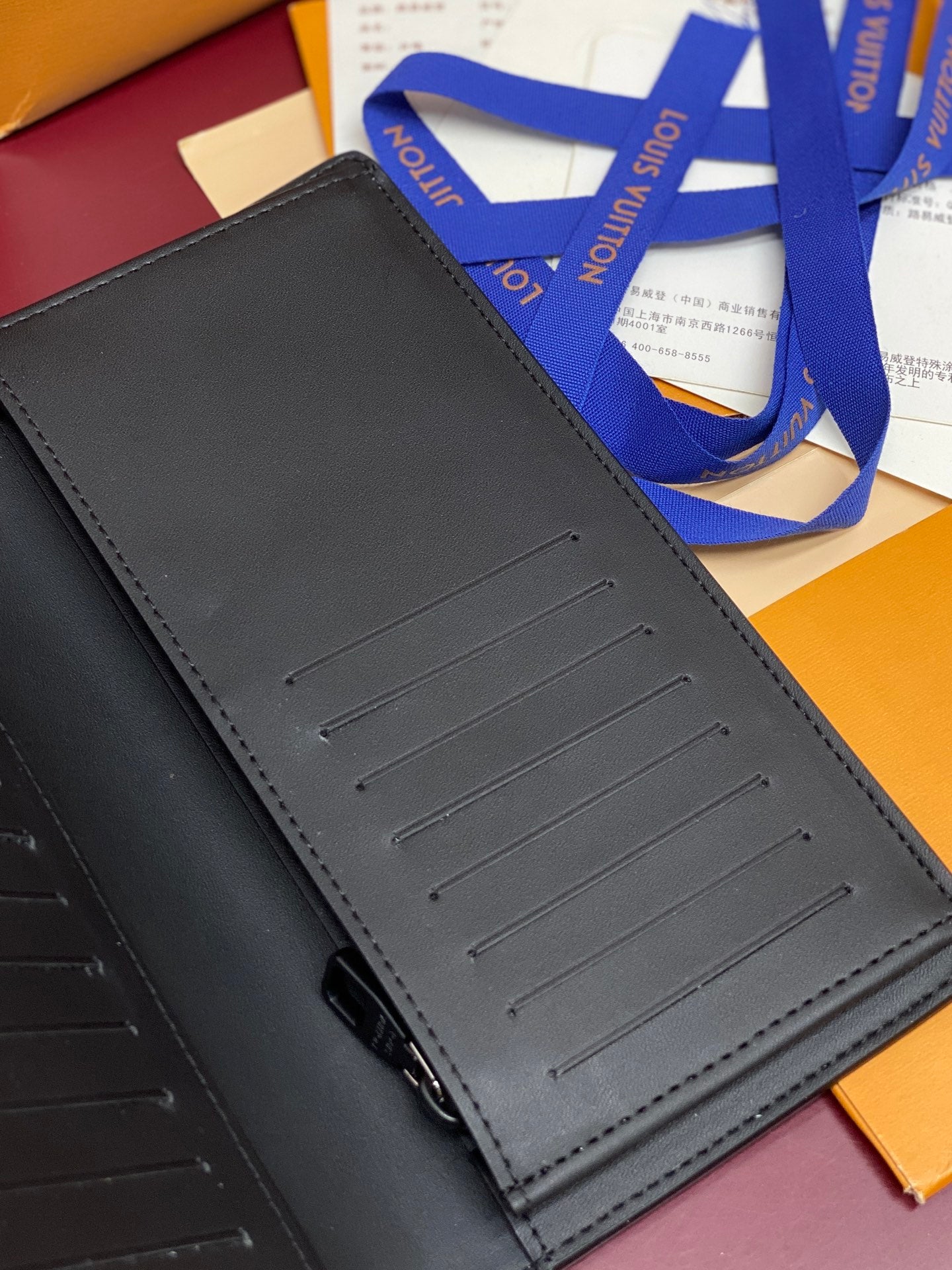 Small wallet bag exterior with card slot panel detail, dark leather finish