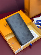 Small wallet bag in dark blue textured finish, shown in an open box