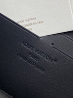 Small zip pouch detail with embossed Louis Vuitton logo on textured black leather