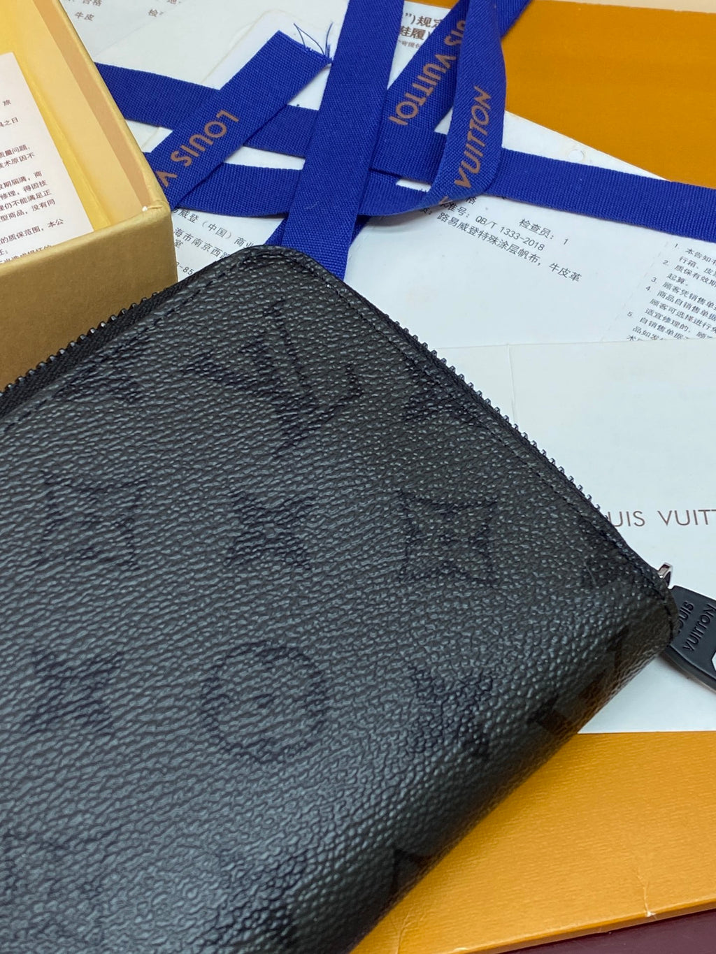 Small zip pouch close-up of textured black exterior and zipper edge