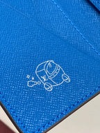 Small bag card holder close-up of blue leather with line icon and Louis Vuitton imprint