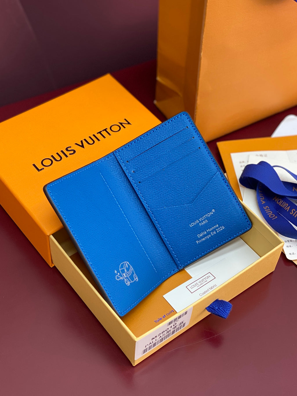 Small bag card holder with blue exterior and Louis Vuitton logo on front