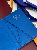 Small bag card holder interior view with blue leather and Louis Vuitton line artwork