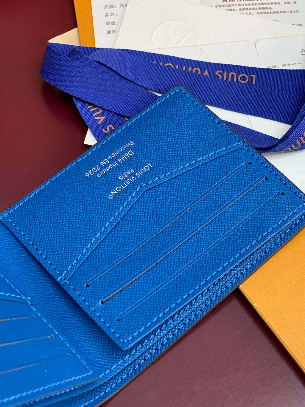 Blue small bag card case with stitched lines and interior slot panel