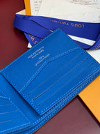 Blue small bag card case with stitched lines and interior slot panel