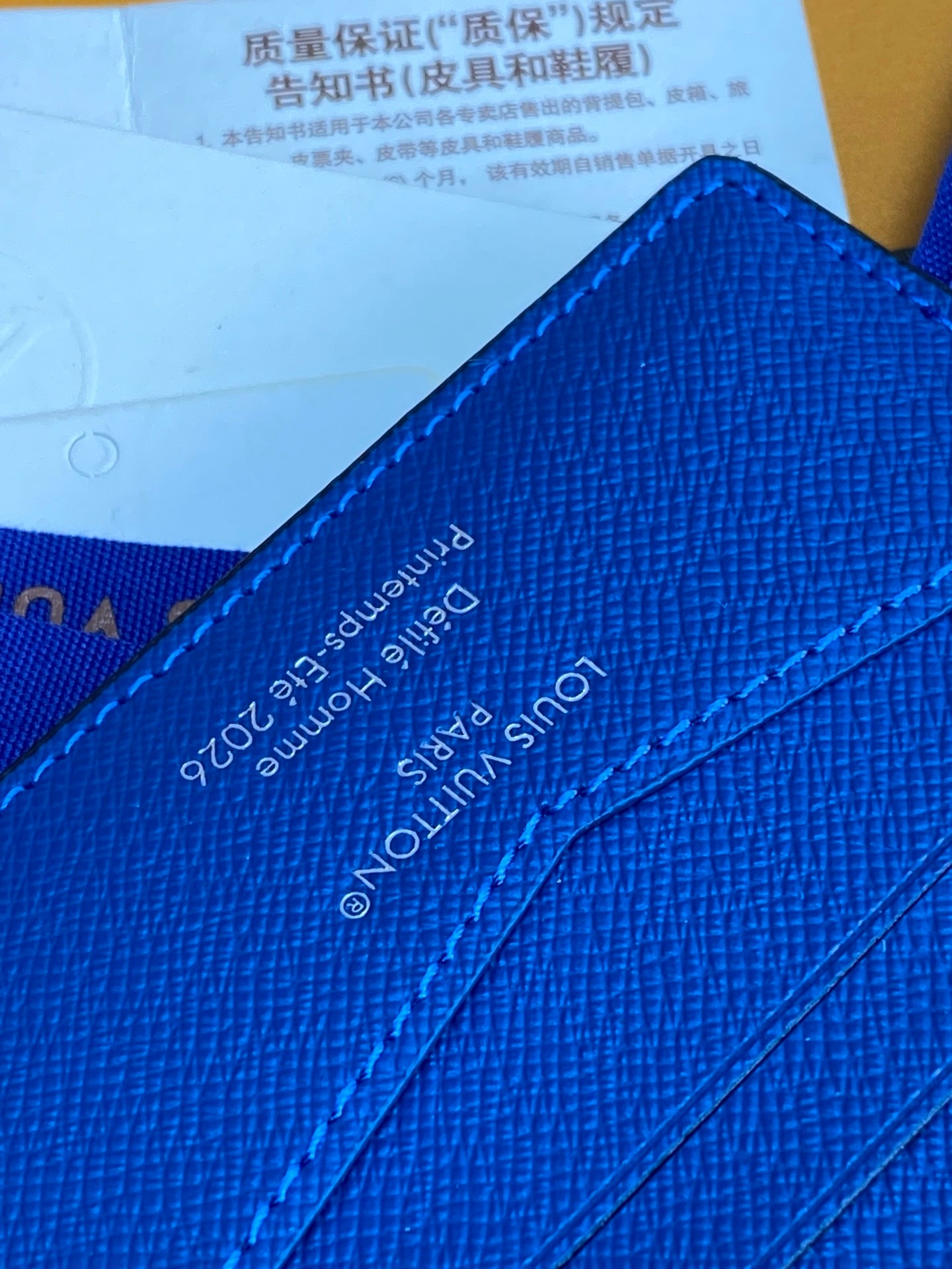 Blue small bag close-up of interior text and stitching lines
