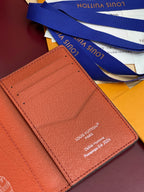 Louis Vuitton small wallet close-up of red interior card slot and stitched logo