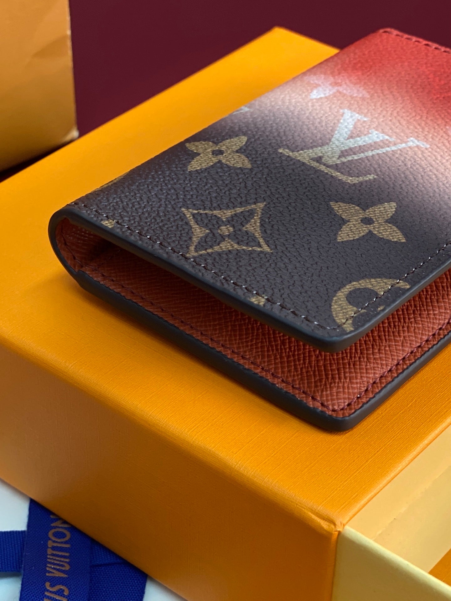 Louis Vuitton small wallet with monogram print and red leather side on box