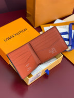 Small bi-fold card wallet open, textured tan leather interior