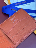 Small bi-fold card wallet close-up, tan leather with card slot stitching