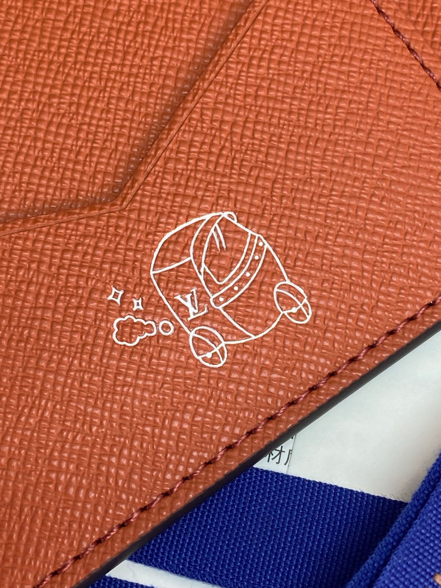 Brown leather Louis Vuitton small bag wallet with line-art icon and stitched border