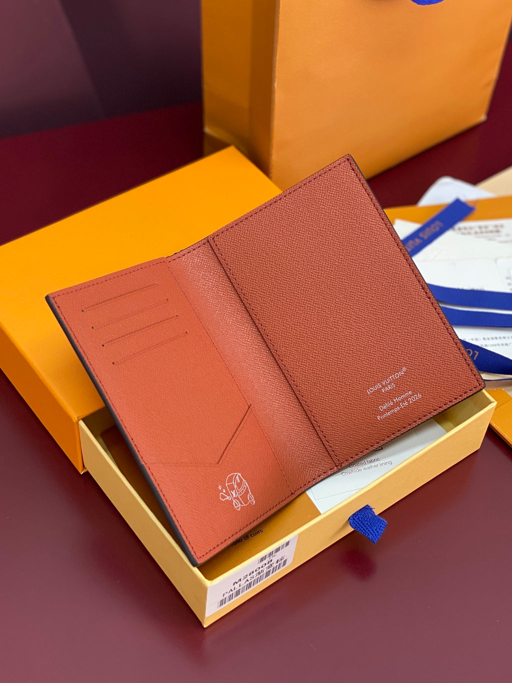 Louis Vuitton small bag wallet open, showing card slots and smooth brown interior