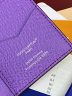 Small bag card holder close-up of purple logo stamp text on textured leather